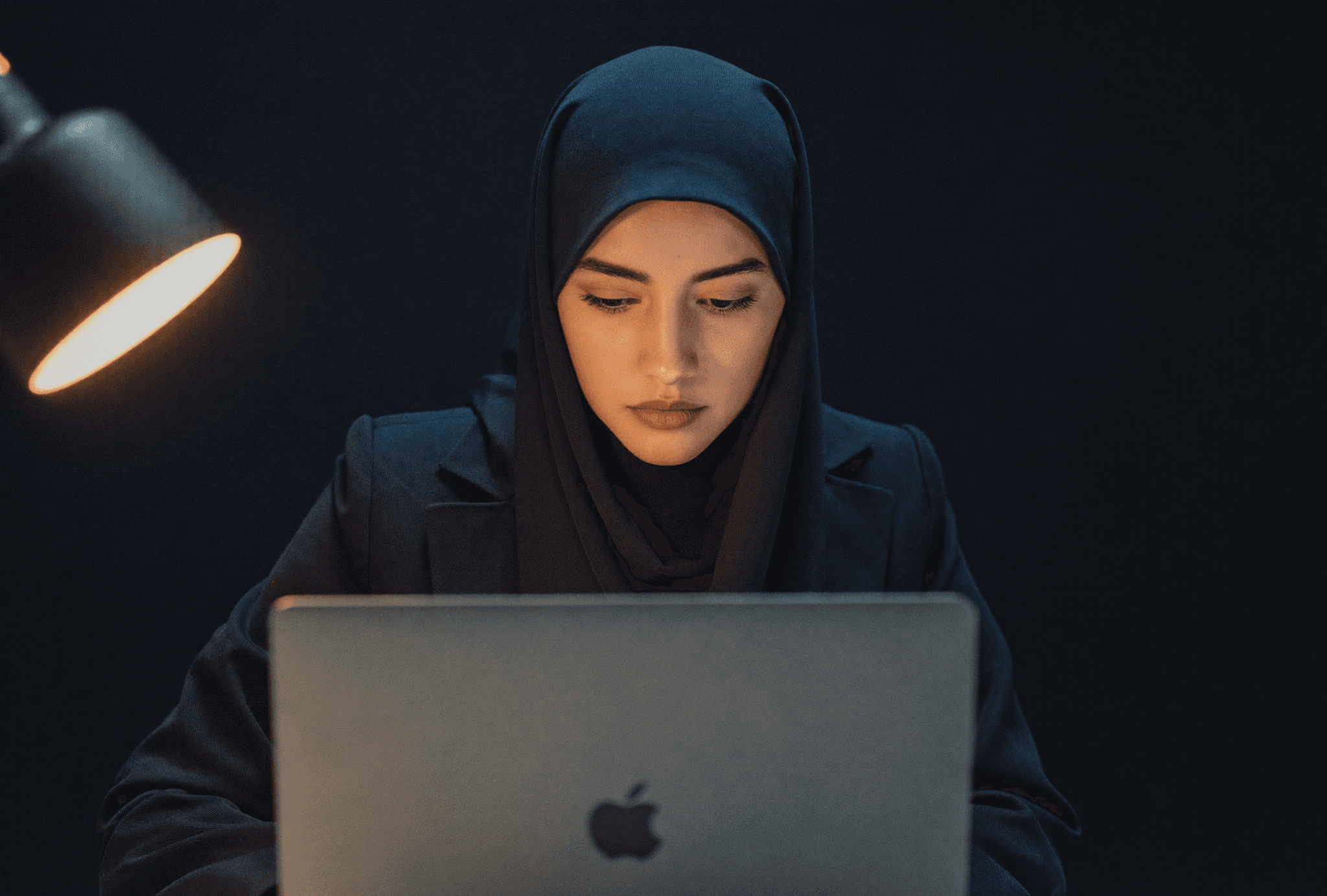 An analyst working with donor data at night
