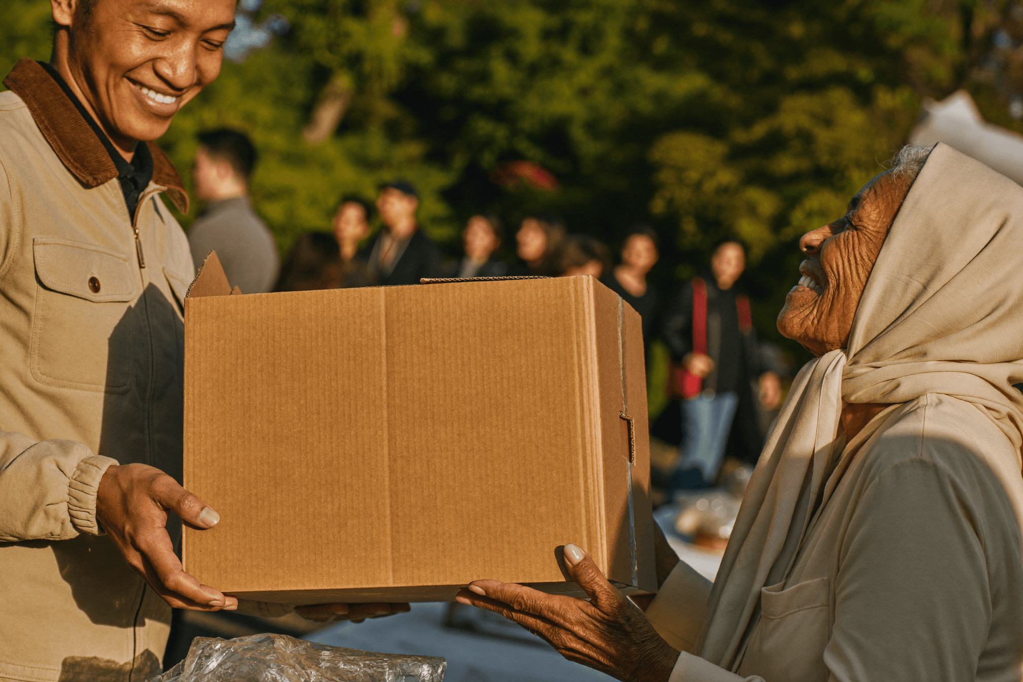 Food aid being handed to an elderly woman at a community distribution